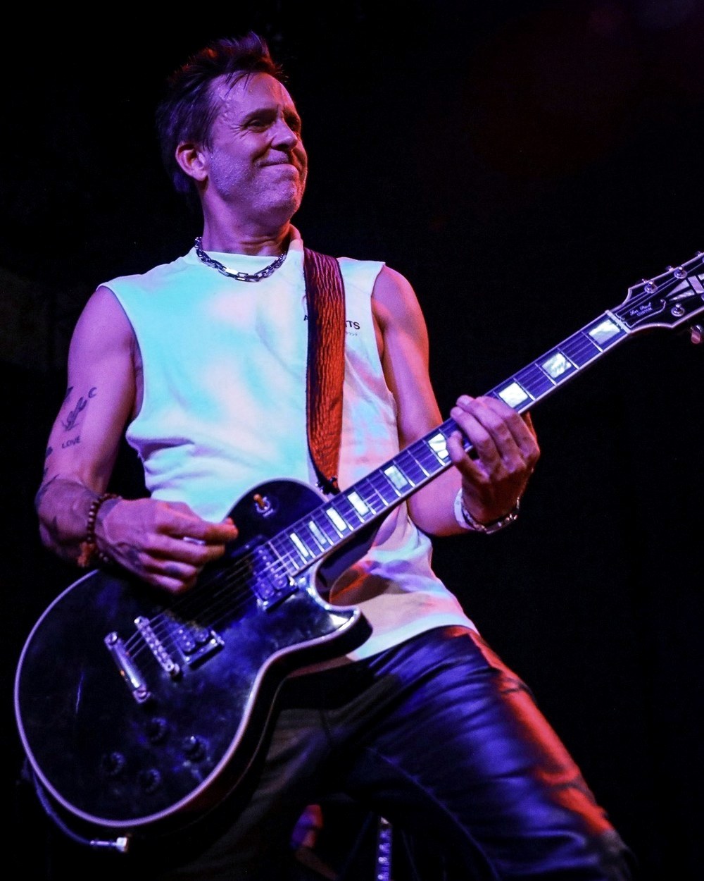 Wesley Geer playing electric guitar on stage